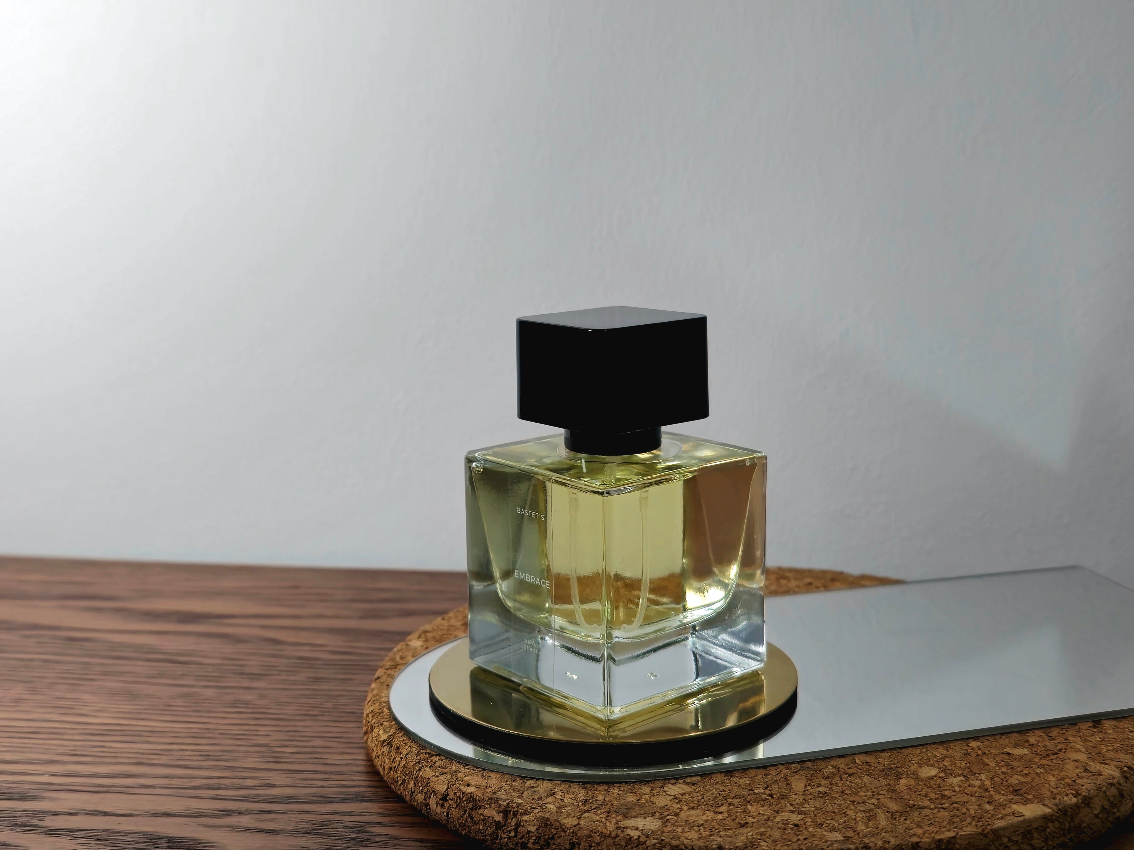 A luxurious bottle of 'Bastet's Embrace' perfume from Circadian Magicks. The glass bottle contains a rich, golden fragrance oil consecrated to the Goddess Bastet. Designed for long-lasting wear and spiritual intention.