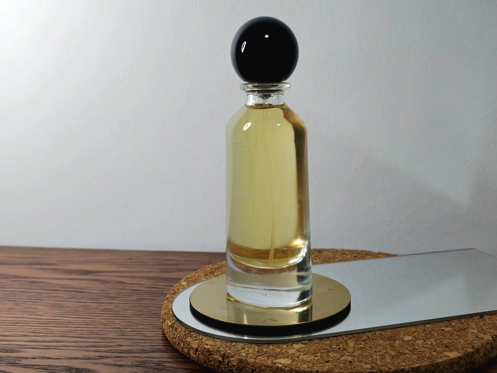 A luxurious bottle of 'Bastet's Embrace' perfume from Circadian Magicks. The glass bottle contains a rich, golden fragrance oil consecrated to the Goddess Bastet. Designed for long-lasting wear and spiritual intention.