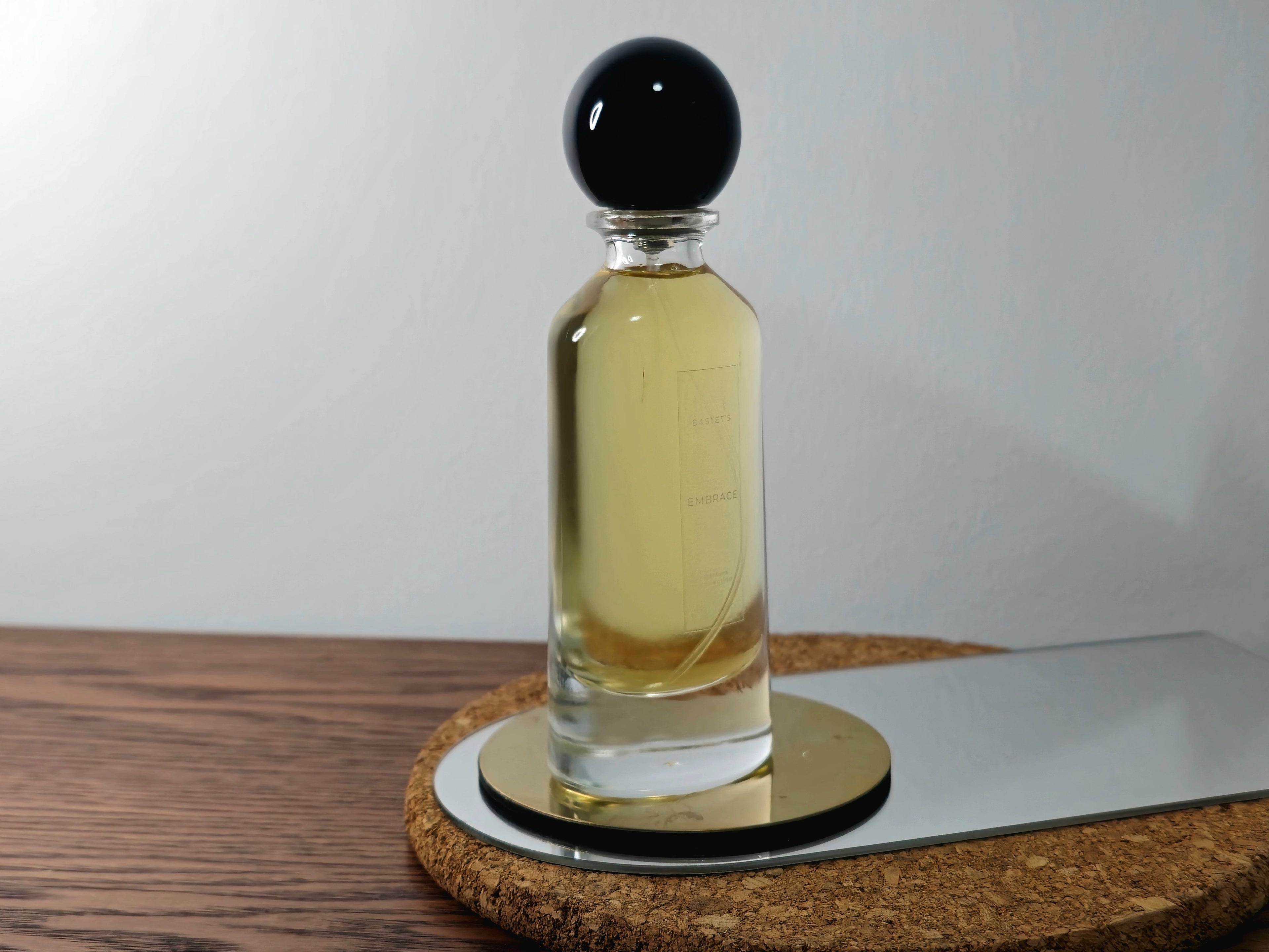 A luxurious bottle of 'Bastet's Embrace' perfume from Circadian Magicks. The glass bottle contains a rich, golden fragrance oil consecrated to the Goddess Bastet. Designed for long-lasting wear and spiritual intention.